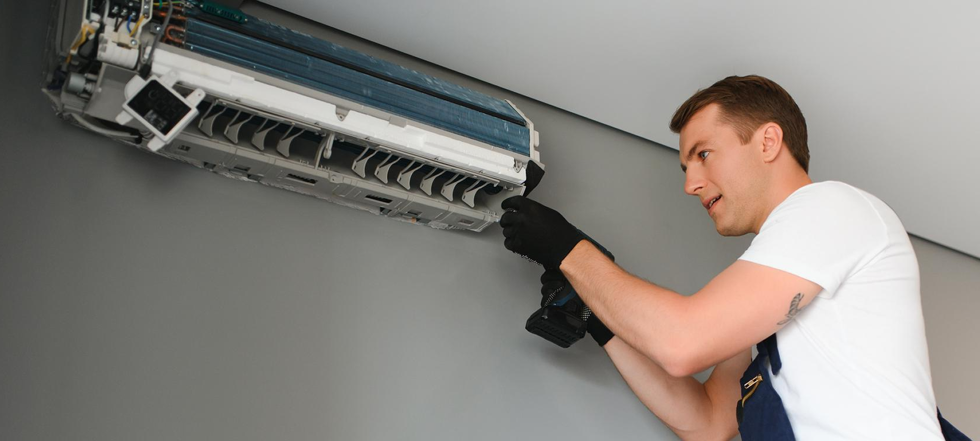 A man is fixing an air conditioner