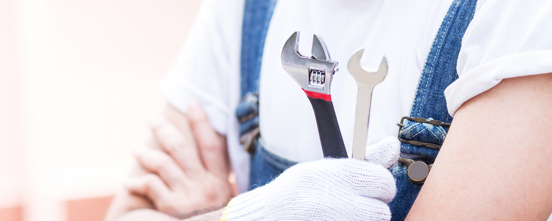 A man holding a wrench